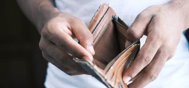 person holding brown leather bifold wallet by Towfiqu barbhuiya courtesy of Unsplash.